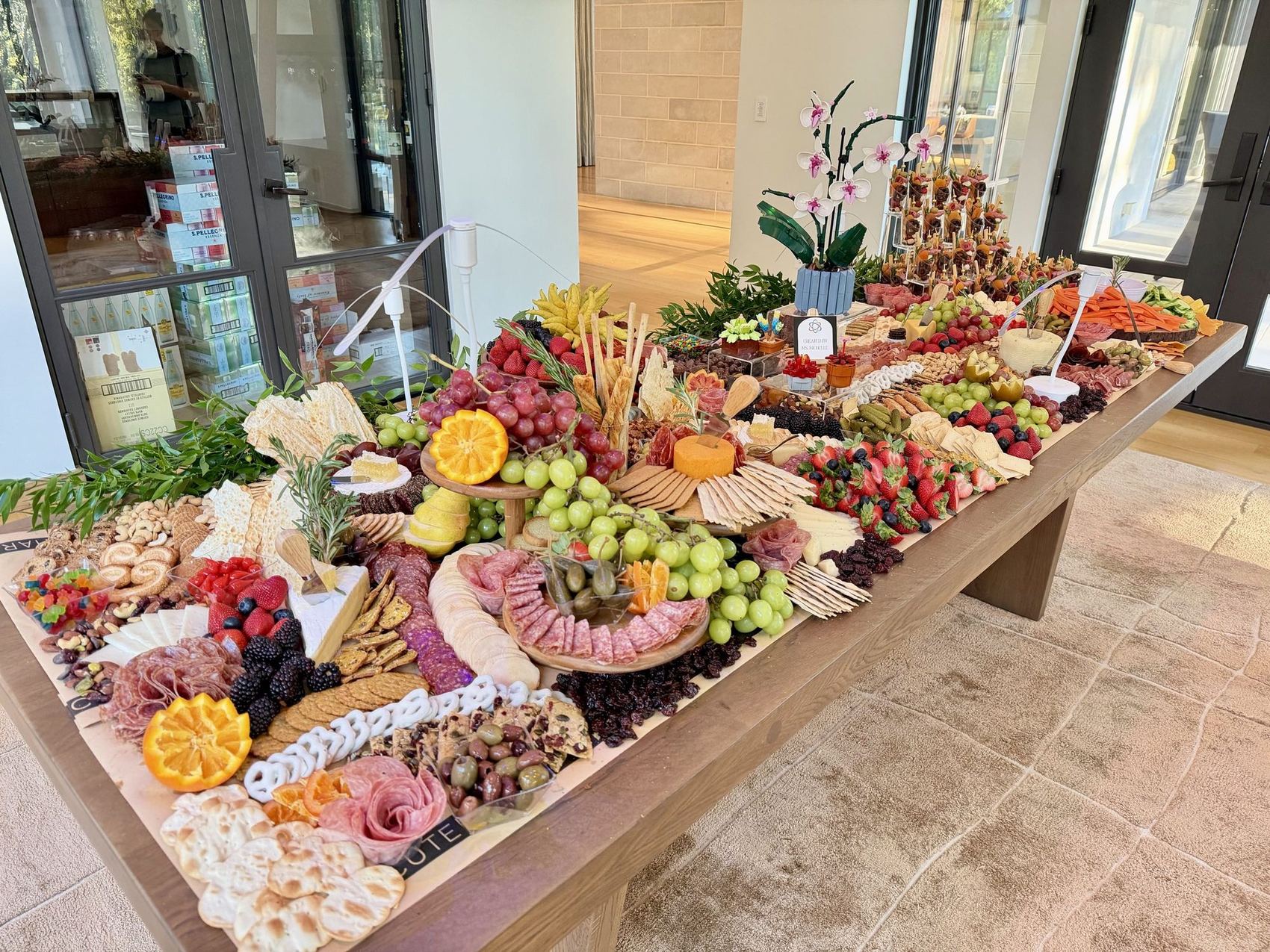 A grazing table built along a long wooden bench.